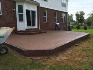 A patio with steps leading to the back of the house.