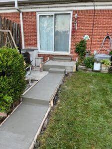 A walkway with steps leading to the back yard.