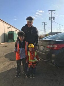 A man and two boys standing next to each other.