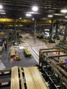 A factory with workers working on the floor.