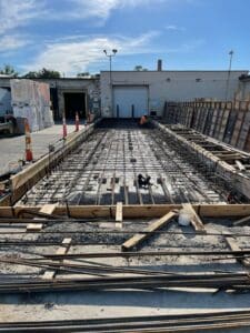 A concrete slab being poured for the building.